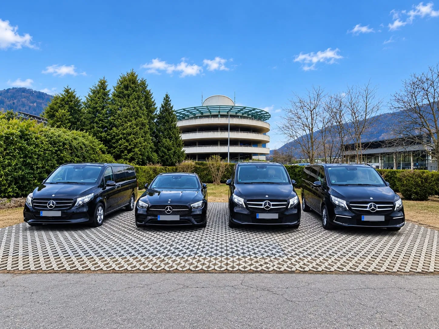 Our four black Mercedes at Innsbruck Airport: three vans and a saloon car